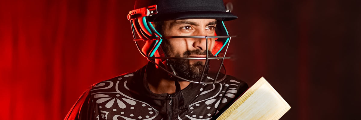 Cricketer in helmet with bat