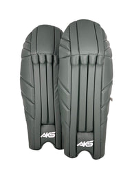 AKS CRICKET professional wicket-keeping pads in a sleek green finish with reinforced panels for impact protection.