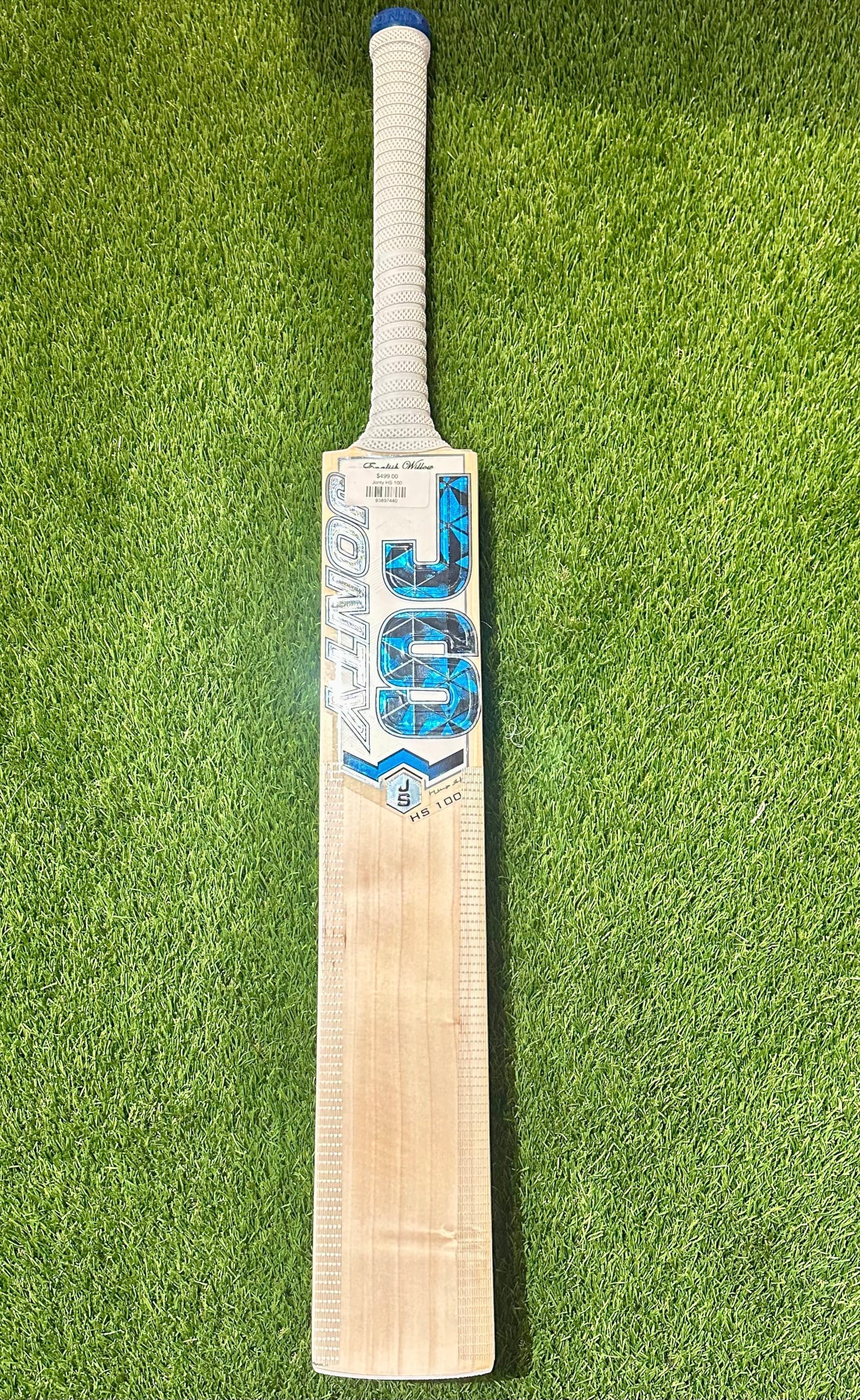 Jonty HS 100 cricket bat made from Grade 2 English willow with blue and silver branding on green grass