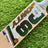 Jonty Master Grade-1 English Willow cricket bat with gold and green branding on a grass background