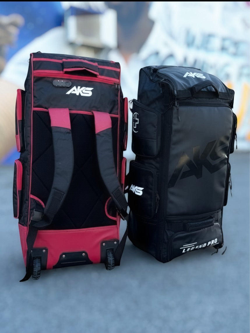 Two AKS CRICKET Legend Pro wheeled cricket kit bags in black and red, featuring durable straps and spacious storage.