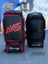 Two AKS CRICKET Legend Pro wheeled cricket kit bags in black and red, featuring durable fabric and multiple pockets.