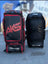 Two AKS CRICKET Legend Pro wheeled cricket kit bags in black and red, featuring durable fabric and multiple pockets.