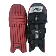 AKS CRICKET Legend maroon batting pads featuring a three-bolster face, moulded knee roll, and black adjustable straps.