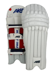 AKS CRICKET Pro Junior white batting pads with high-density foam, reinforced knee protection, and adjustable straps.