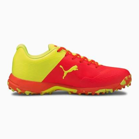 AKS CRICKET Puma 19 FH rubber cricket shoes in bright orange and yellow with breathable mesh and rubber spike outsole