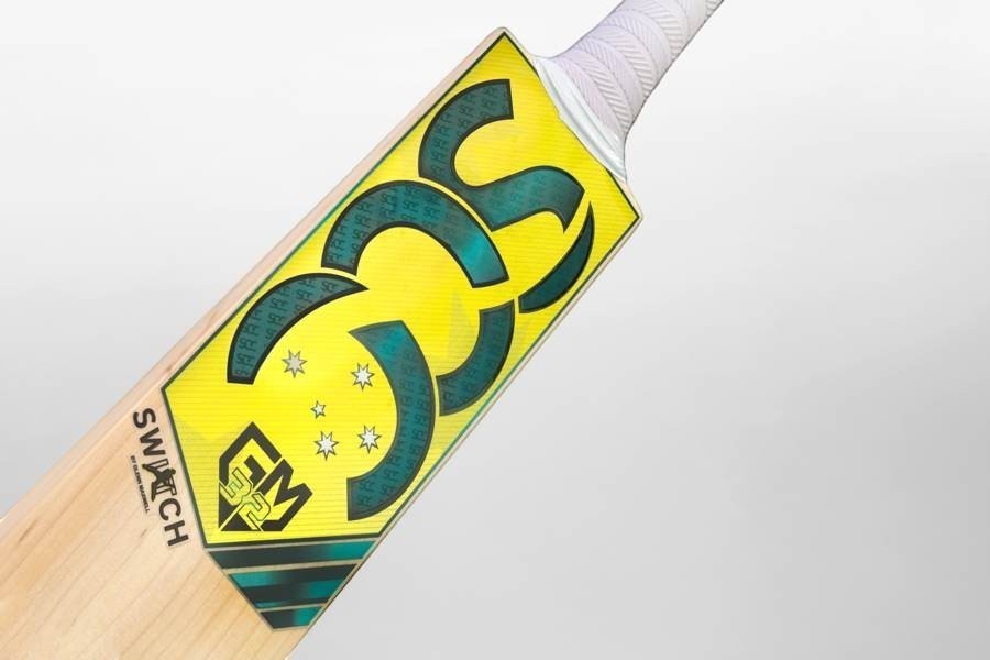 SCC SWITCH Rush Gold junior English willow cricket bat with yellow and black branding details.